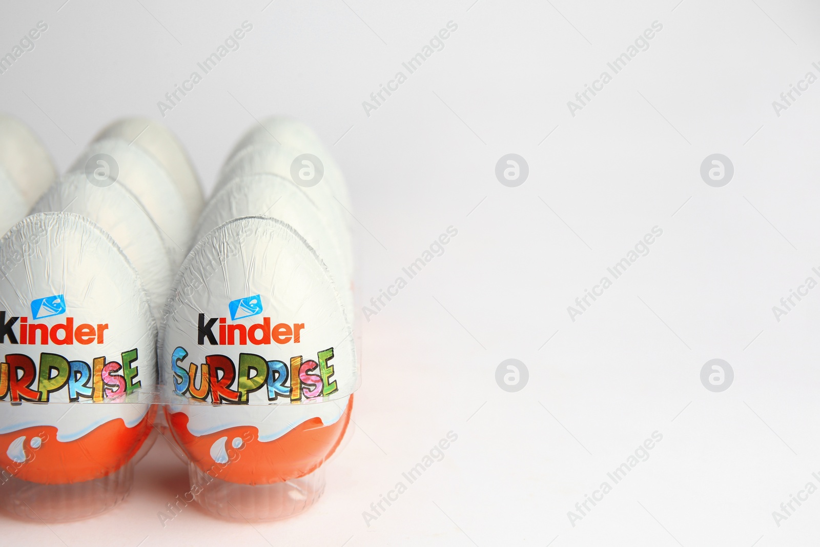 Photo of Sveti Vlas, Bulgaria - June 26, 2023: Kinder Surprise Eggs in plastic tray on white background. Space for text