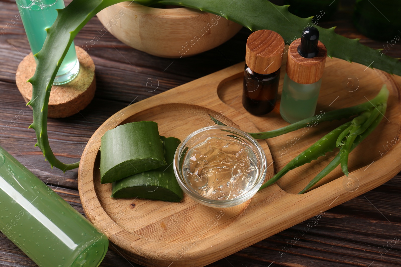 Photo of Homemade aloe gel and fresh ingredients on wooden table