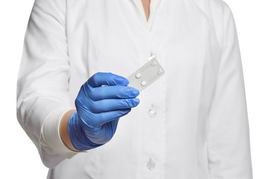 Doctor holding blister of emergency contraception pills on white background, closeup