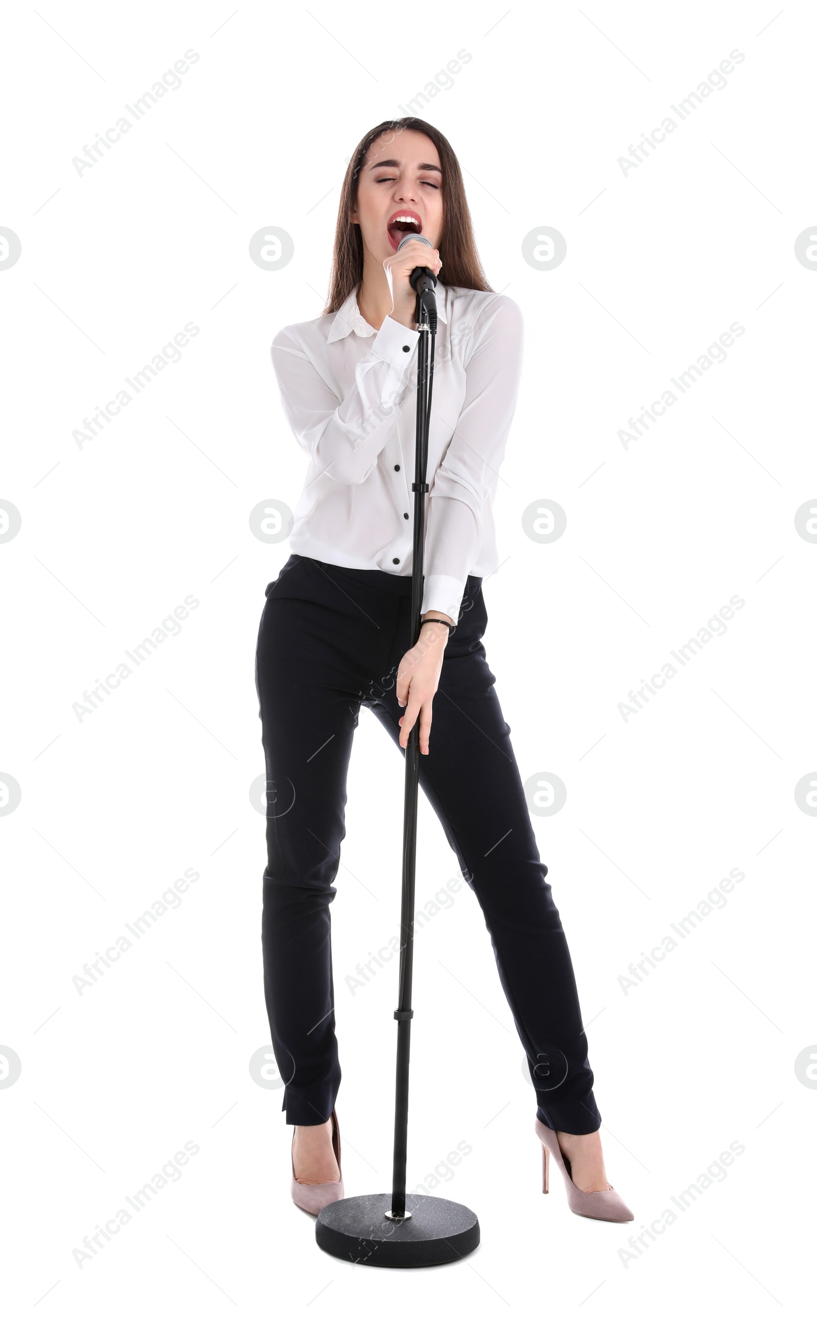 Photo of Young stylish woman singing in microphone on white background