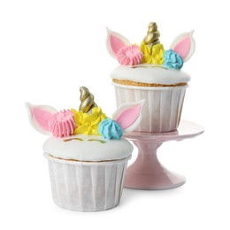 Photo of Cute sweet unicorn cupcakes on white background