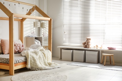 Photo of Cozy child room interior with comfortable bed