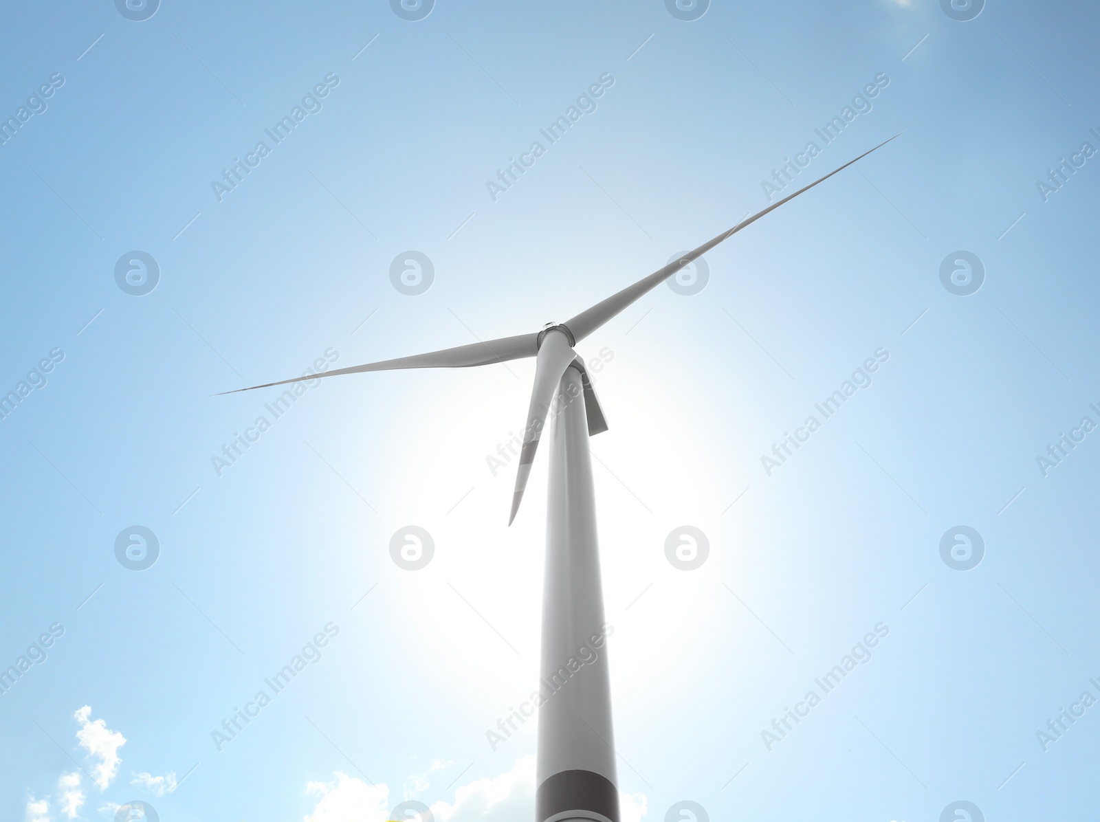 Photo of Modern wind turbine against blue sky, low angle view. Energy efficiency