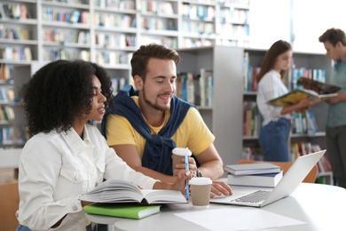 Group of young people studying in library