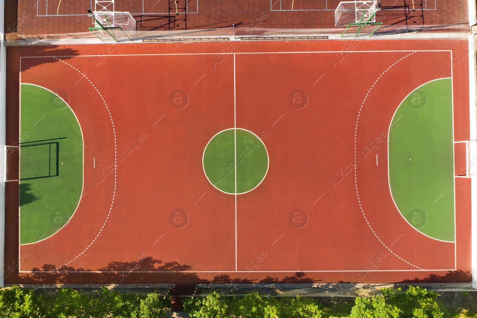 Image of Aerial view of football pitch on sunny day