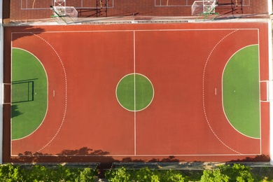 Image of Aerial view of football pitch on sunny day