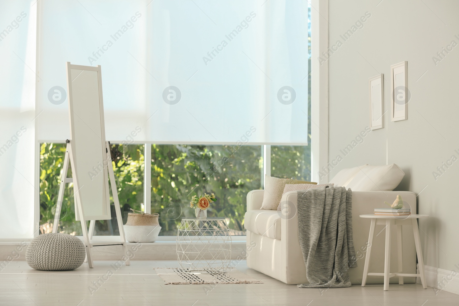 Photo of Elegant mirror near window in stylish living room interior