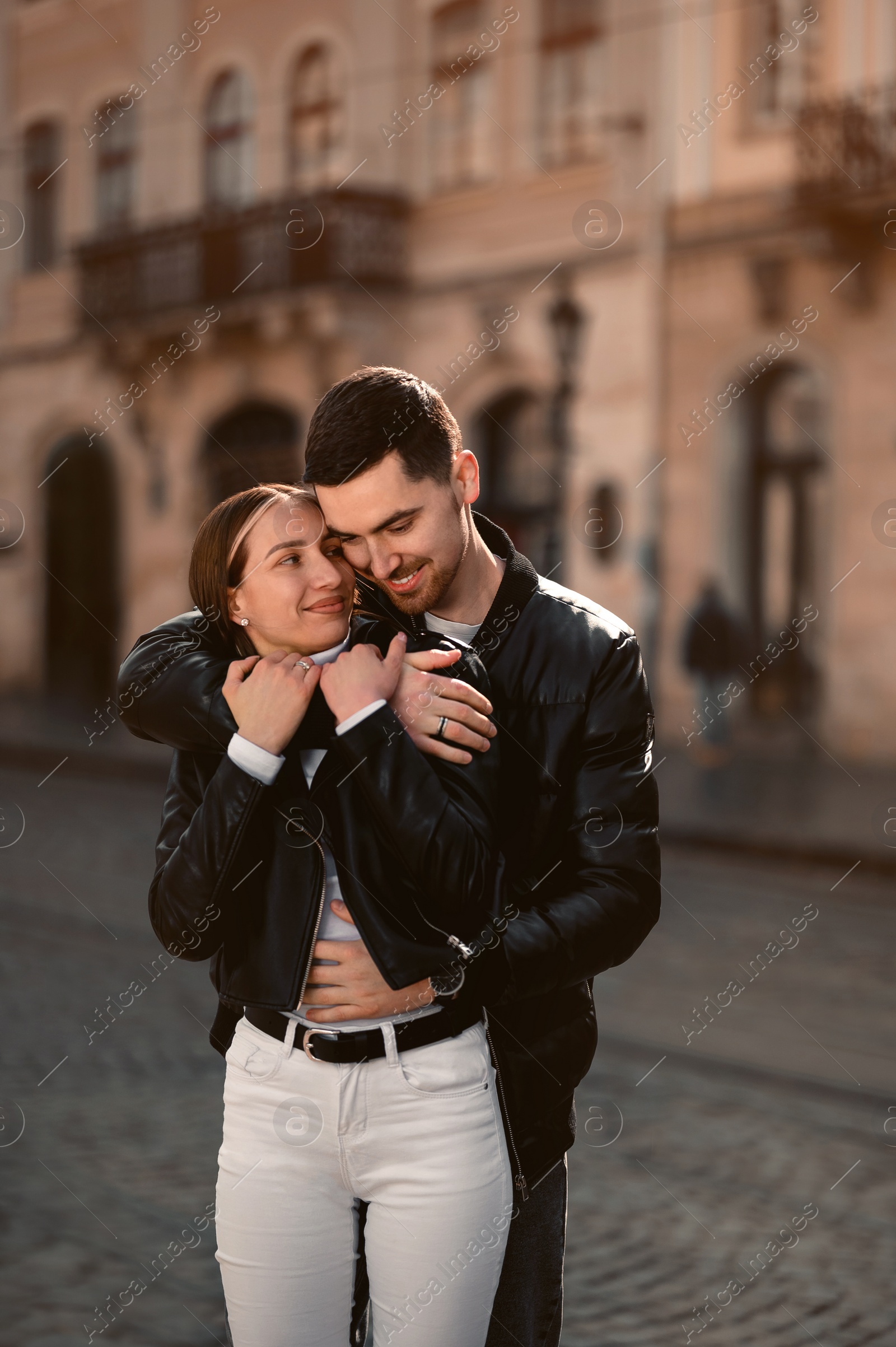 Photo of Lovely young couple together on city street. Romantic date