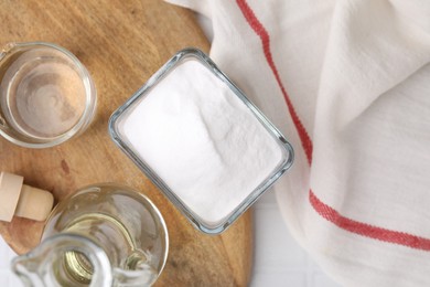 Vinegar and baking soda on table, top view