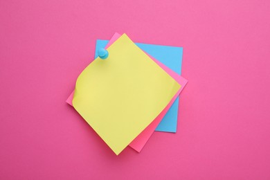 Photo of Colorful empty notes pinned on pink background