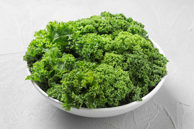 Fresh green kale leaves on white table, closeup