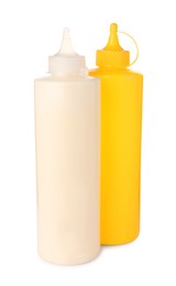 Photo of Plastic bottles of tasty mayonnaise and mustard on white background