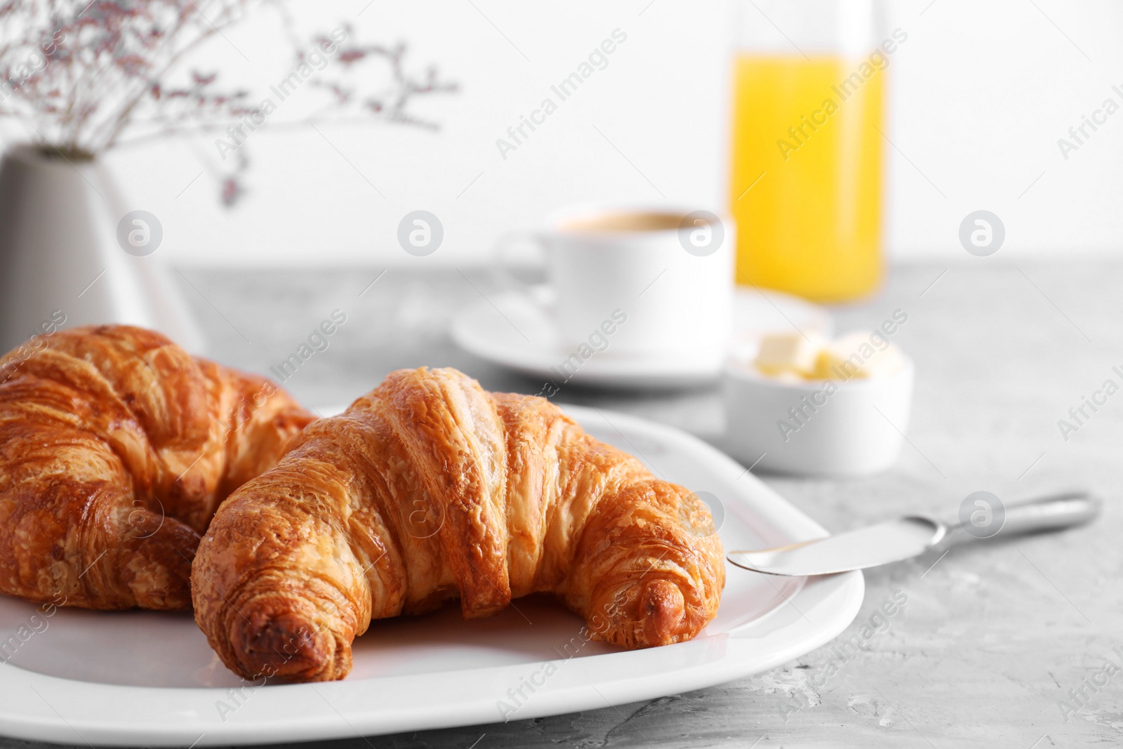 Photo of Tasty breakfast. Fresh croissants on grey table, closeup