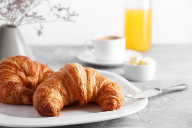 Photo of Tasty breakfast. Fresh croissants on grey table, closeup