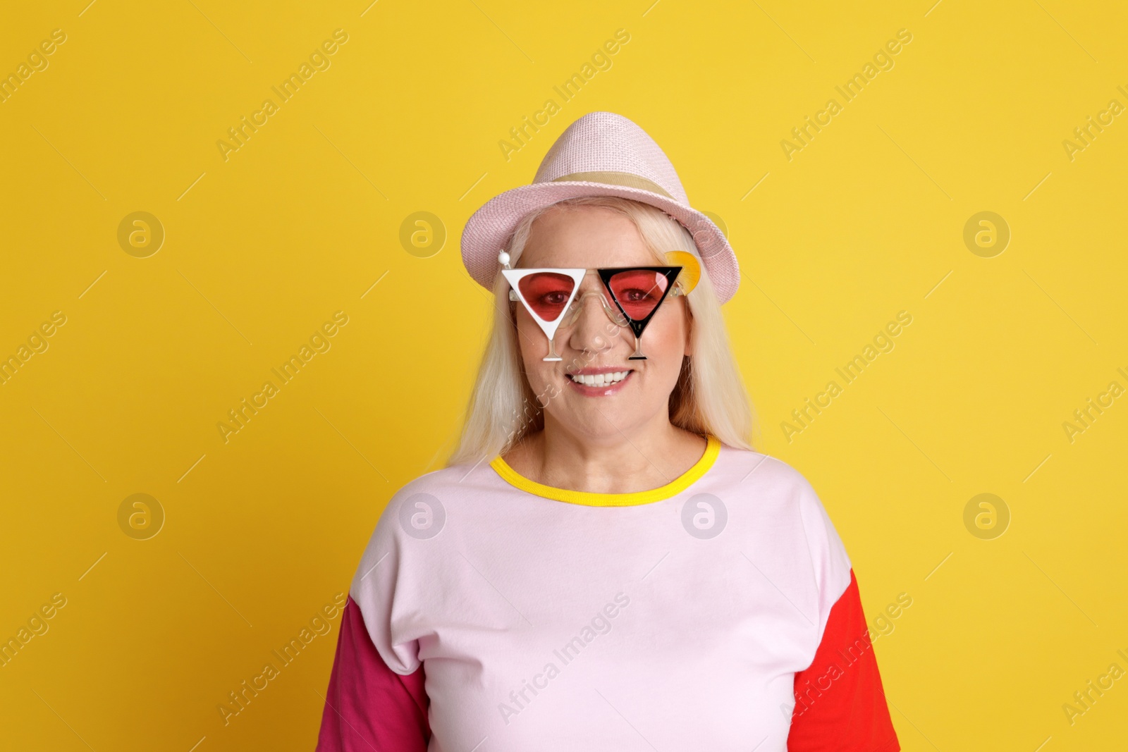 Photo of Portrait of mature woman in hipster outfit on color background