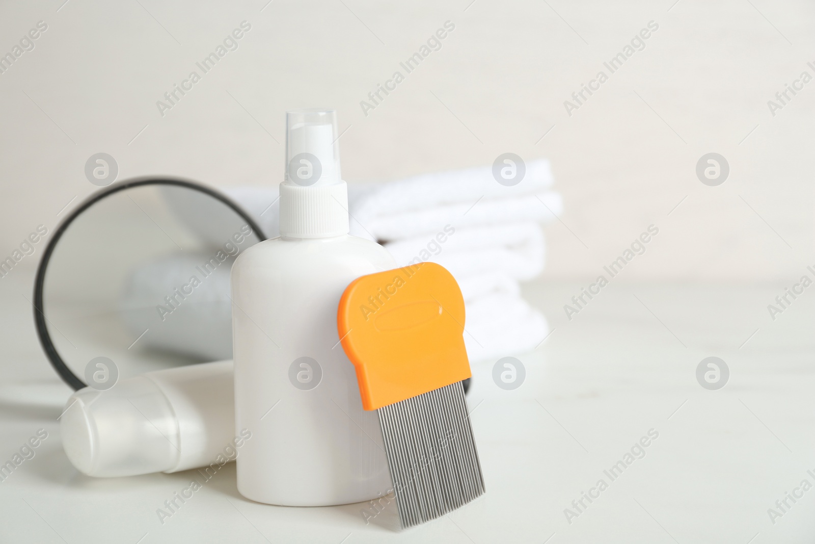 Photo of Cosmetic products, lice comb and magnifying glass on white table. Space for text