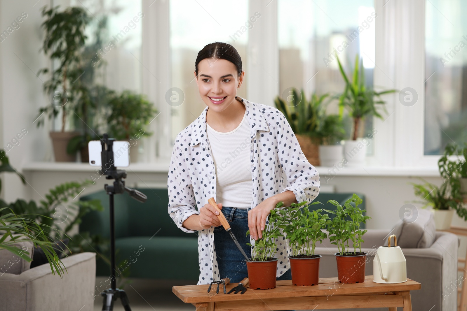 Photo of Teacher conducting online gardening course at home. Time for hobby