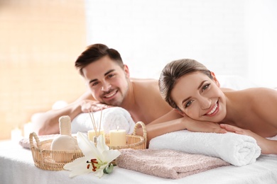 Young couple with spa essentials in wellness center