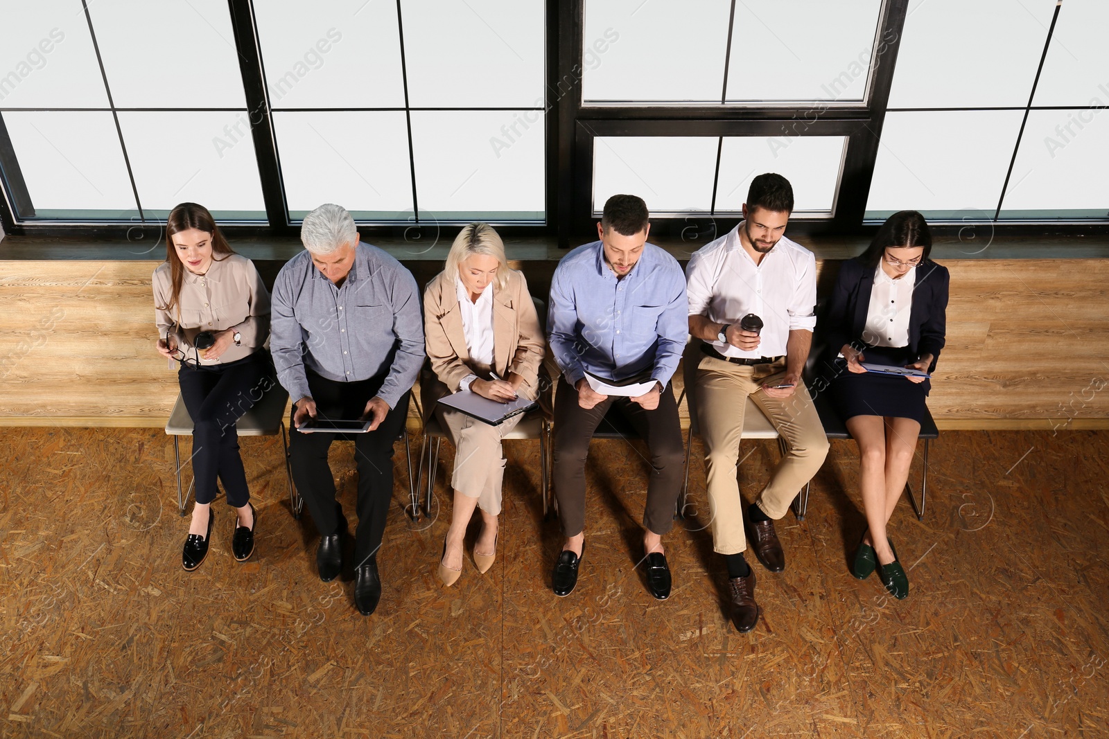 Photo of People waiting for job interview in office hall, above view