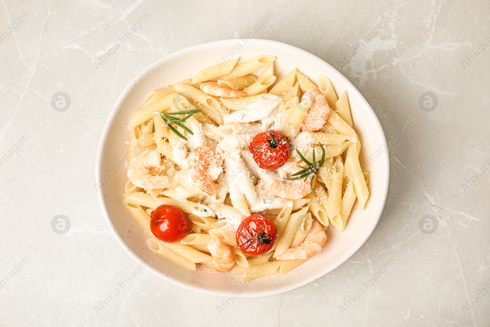 Photo of Delicious pasta with shrimps on marble table, top view