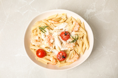 Photo of Delicious pasta with shrimps on marble table, top view