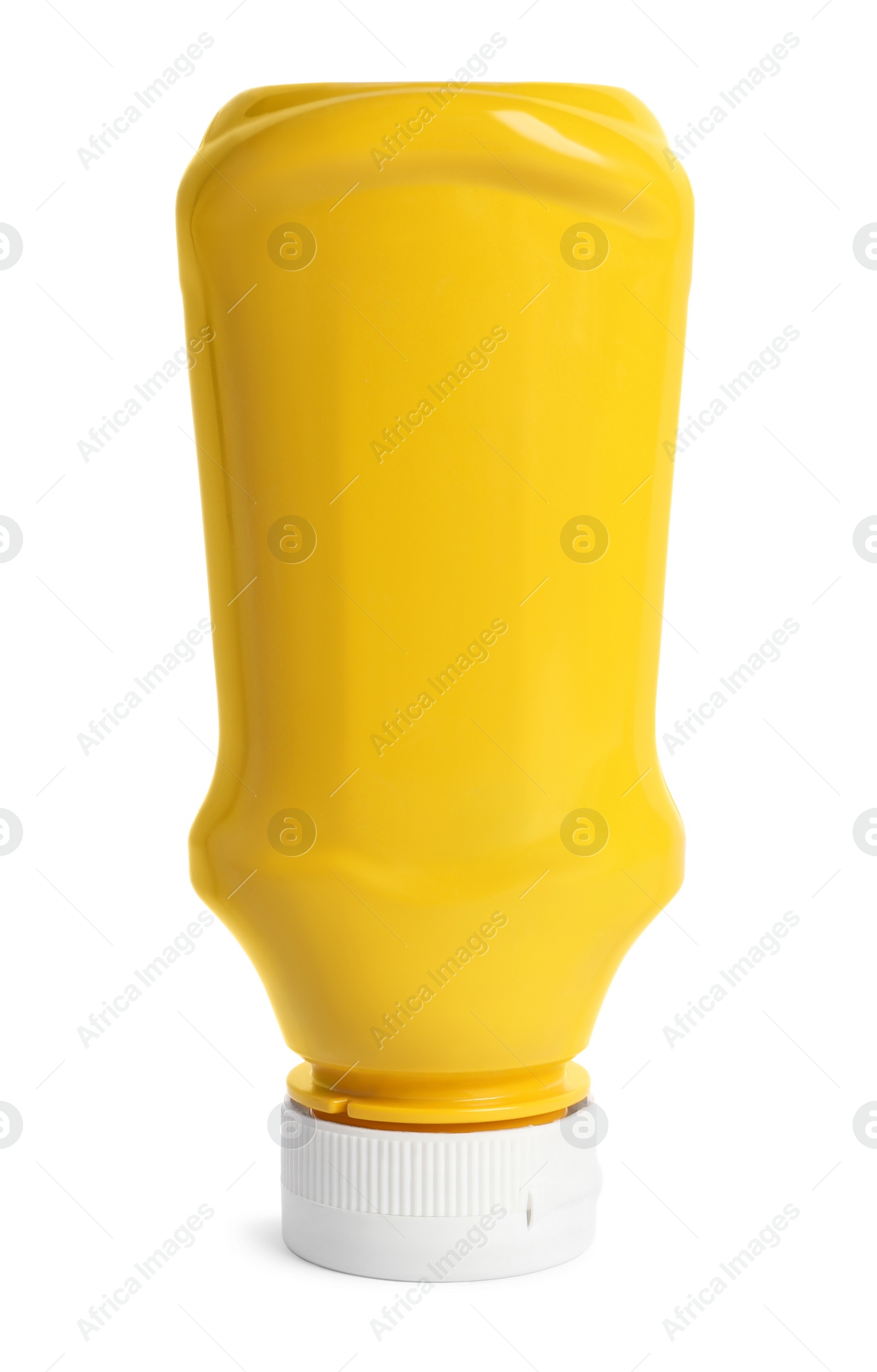 Photo of Spicy mustard in plastic bottle isolated on white