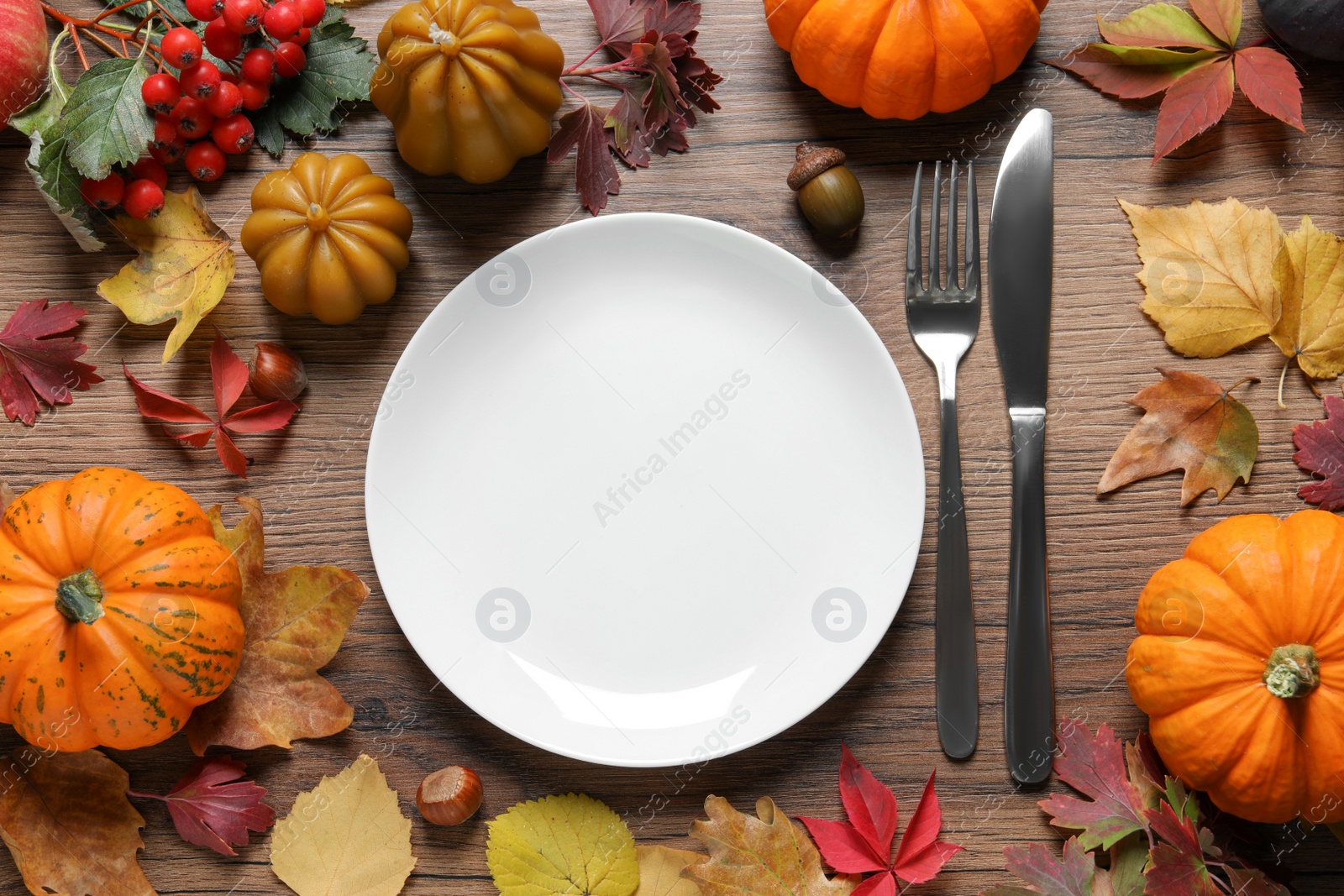 Photo of Festive table setting with autumn decor on wooden background, flat lay