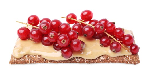 Photo of Fresh crunchy rye crispbread with peanut butter and red currant isolated on white