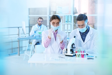 Photo of Young scientists working in laboratory. Chemical analysis