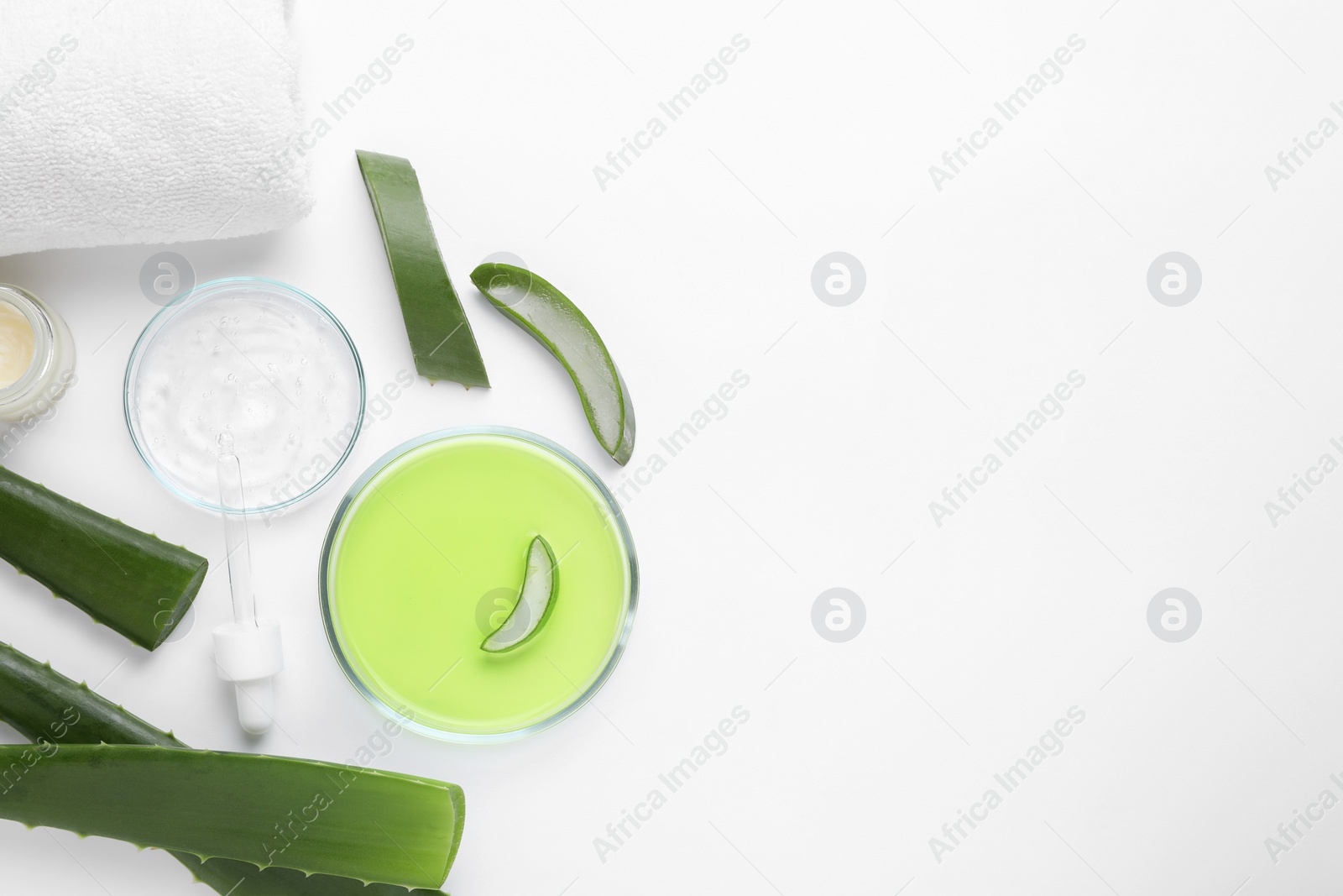 Photo of Flat lay composition with cosmetic products and cut aloe leaves on white background. Space for text