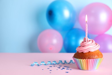 Delicious birthday cupcake on color background, space for text