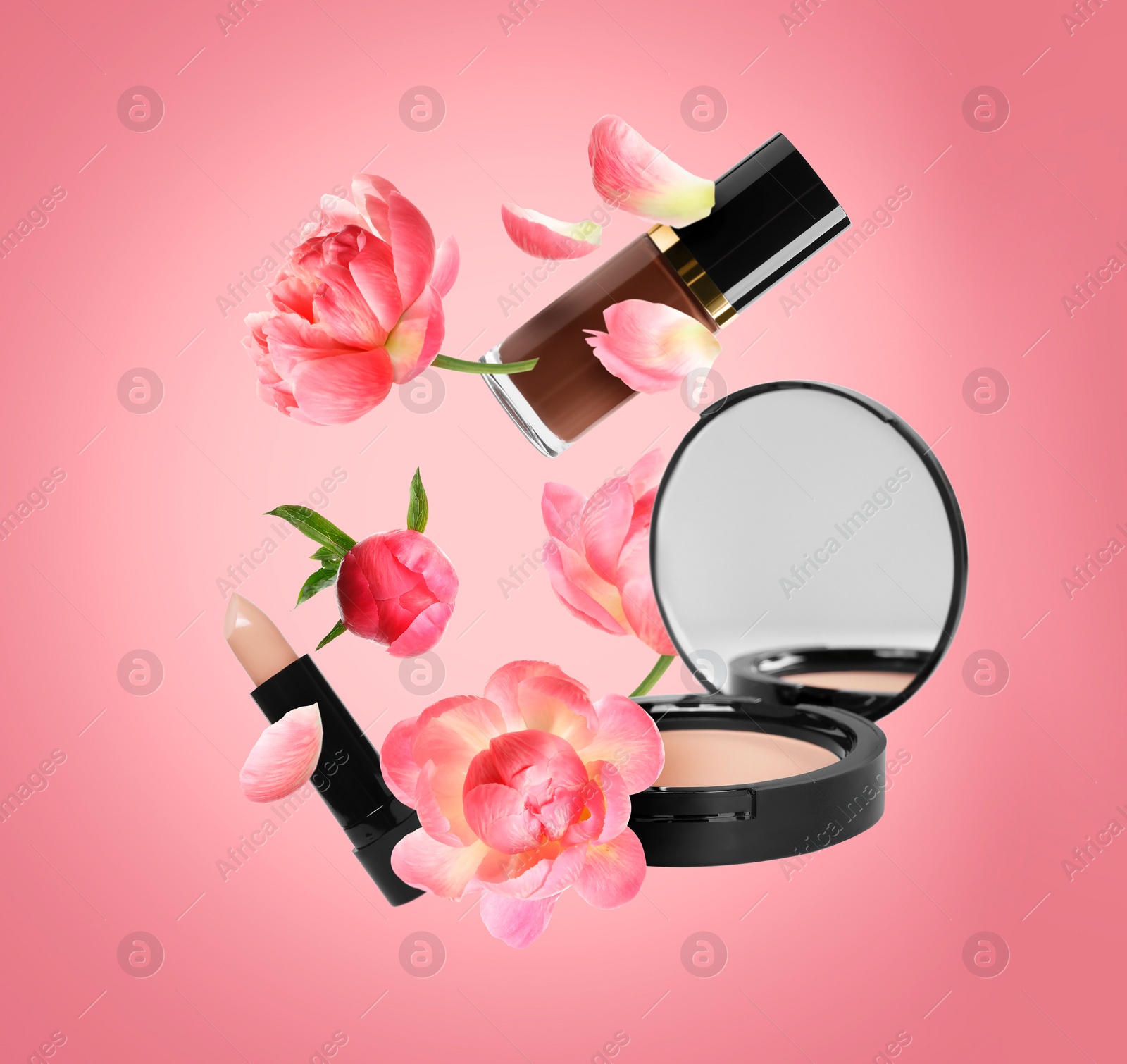 Image of Spring flowers and makeup products in air on coral color background