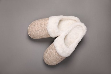 Pair of beautiful soft slippers on grey background, top view