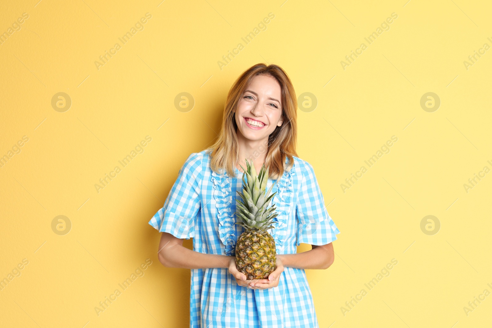 Photo of Happy slim woman with pineapple on color background. Weight loss diet