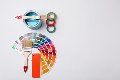 Photo of Set of decorator's tools on light background, flat lay