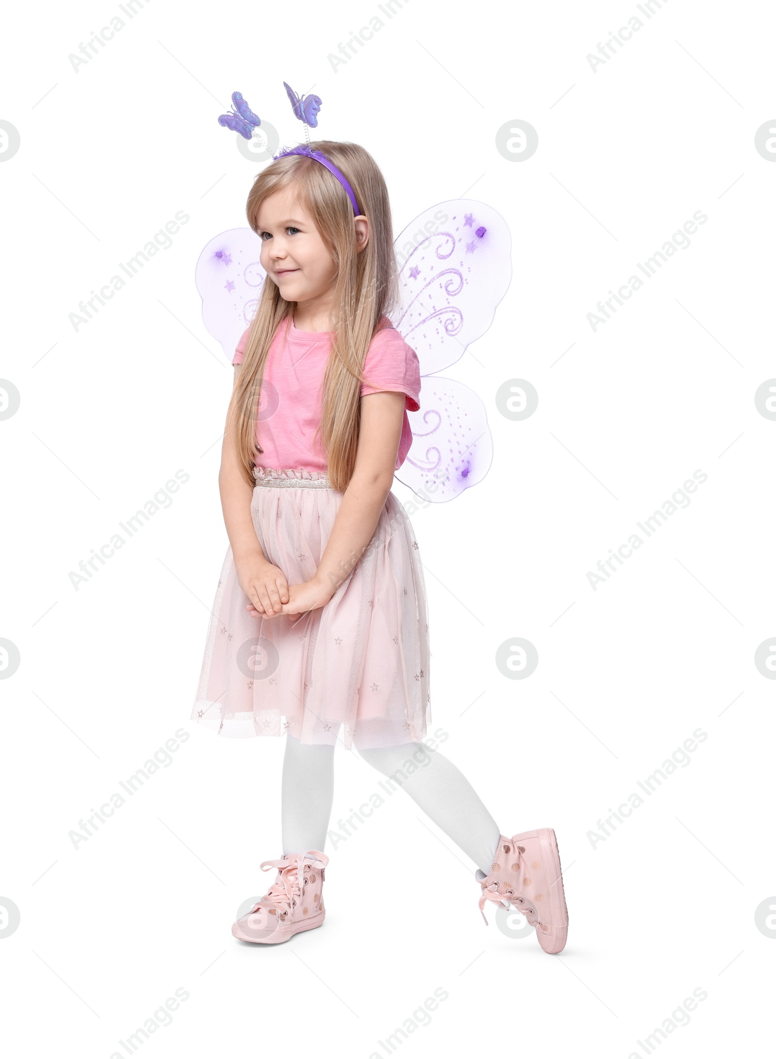 Photo of Cute little girl in fairy costume with violet wings on white background