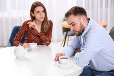 Couple with relationship problems at table in cafe