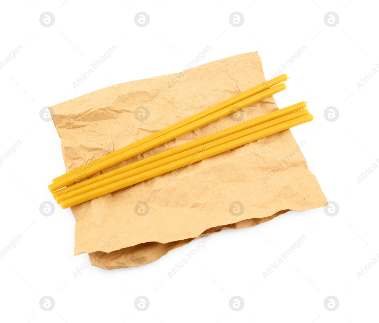 Photo of Parchment and church candles on white background