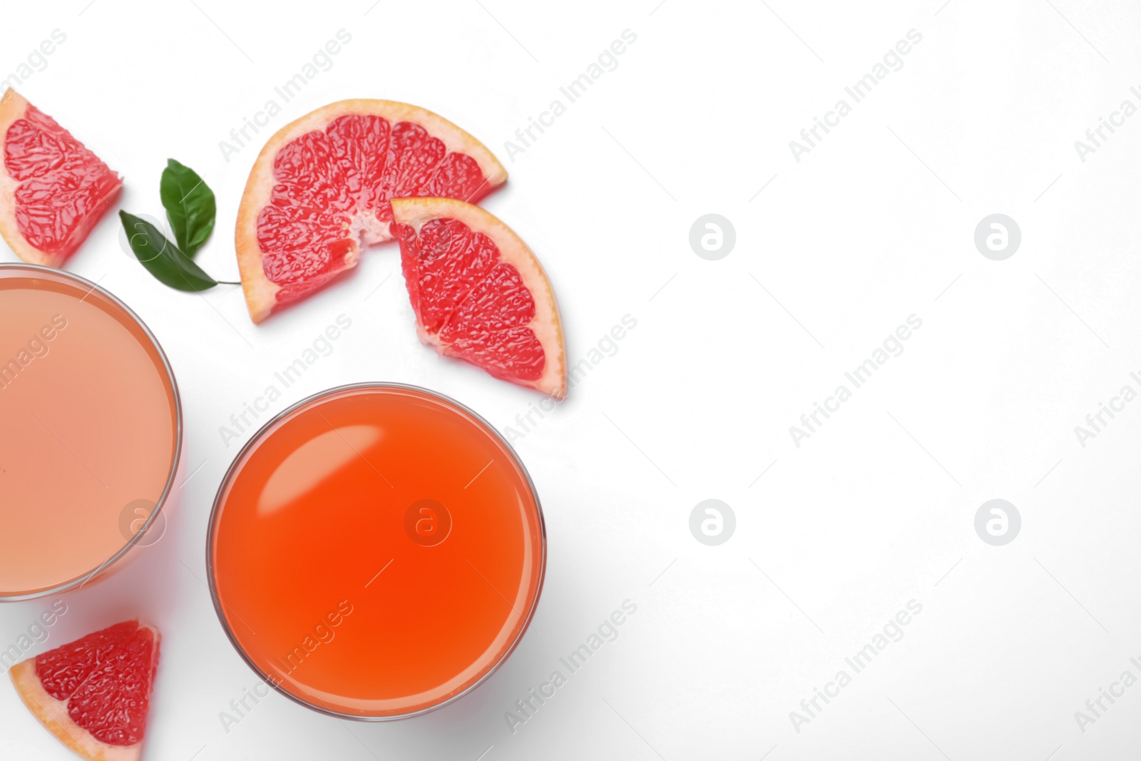 Photo of Tasty freshly made grapefruit juice and fruits on white background, top view