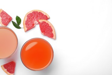 Tasty freshly made grapefruit juice and fruits on white background, top view