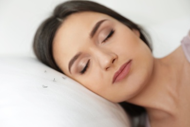 Photo of Young woman with eyelash loss problem sleeping in bed