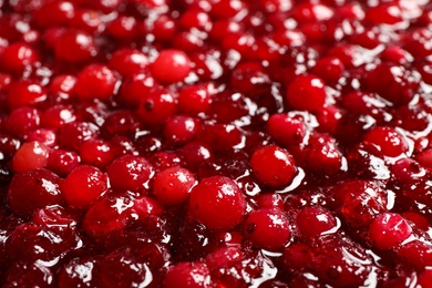 Fresh juicy cranberry sauce as background, closeup