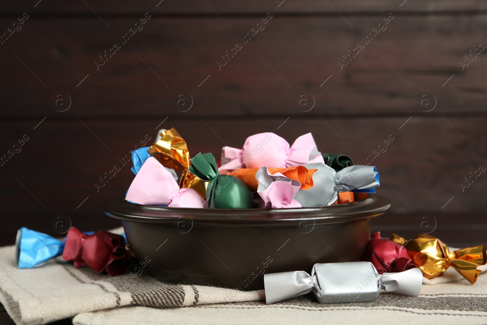 Photo of Candies in colorful wrappers on table, closeup