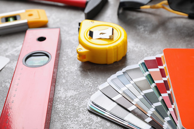 Many different construction tools on grey marble table