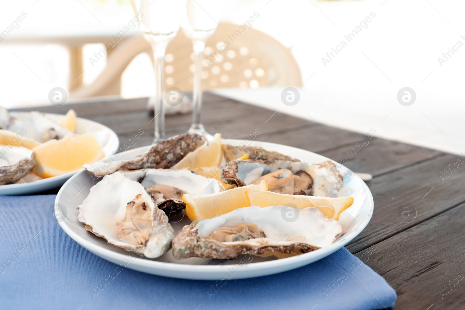 Photo of Fresh oysters with cut juicy lemon served on table