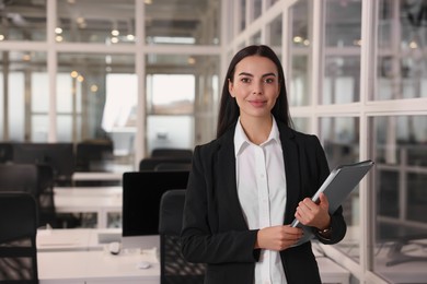 Beautiful woman with folder in office, space for text. Lawyer, businesswoman, accountant or manager