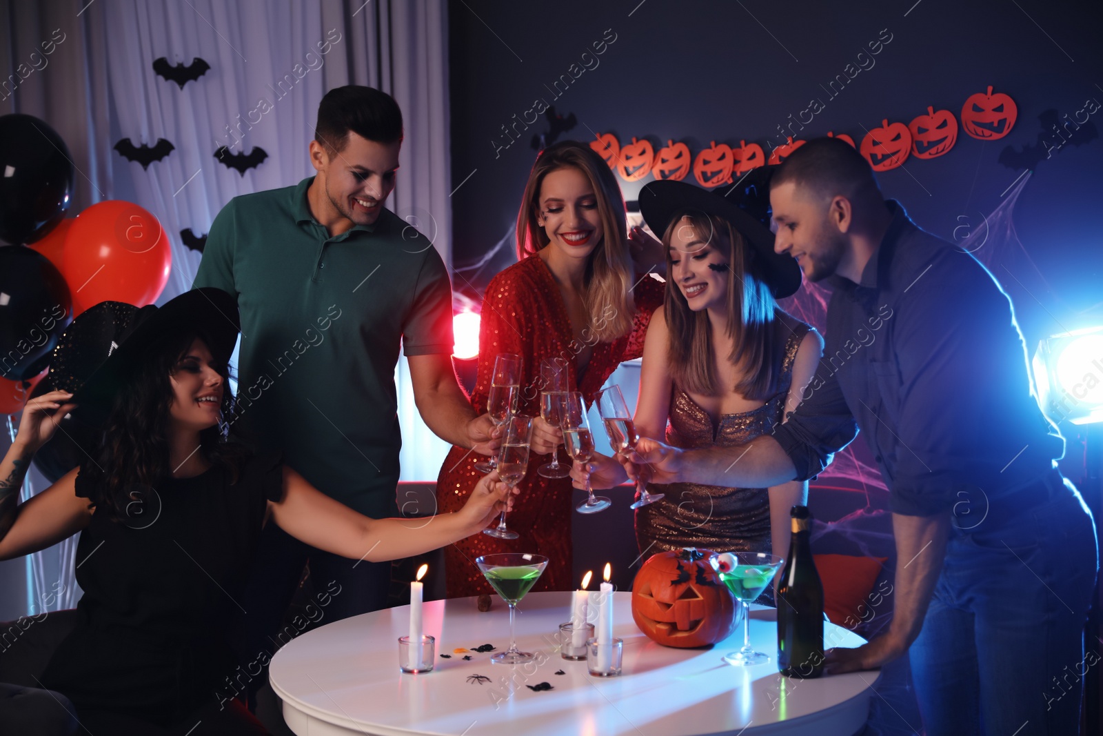 Photo of Group of friends having Halloween party at home