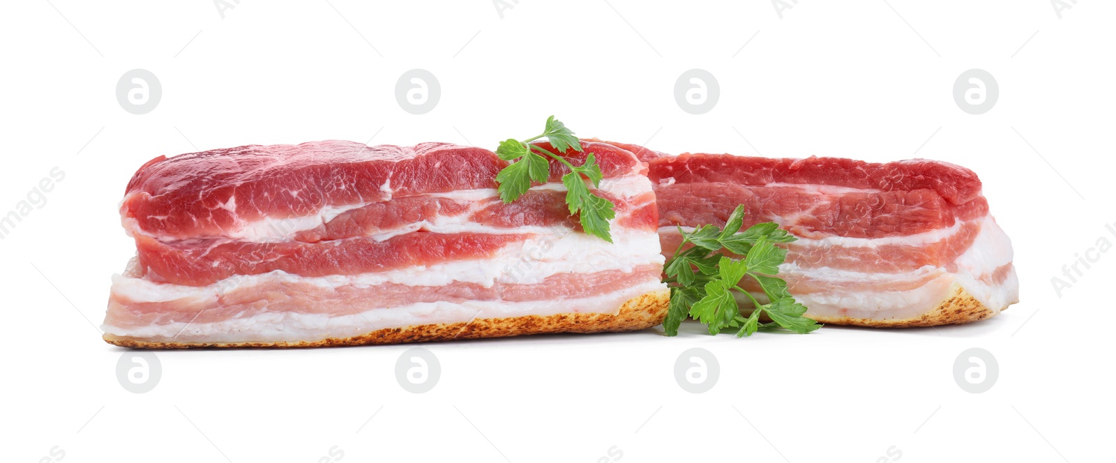 Photo of Pieces of raw pork belly and parsley isolated on white