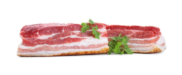 Pieces of raw pork belly and parsley isolated on white