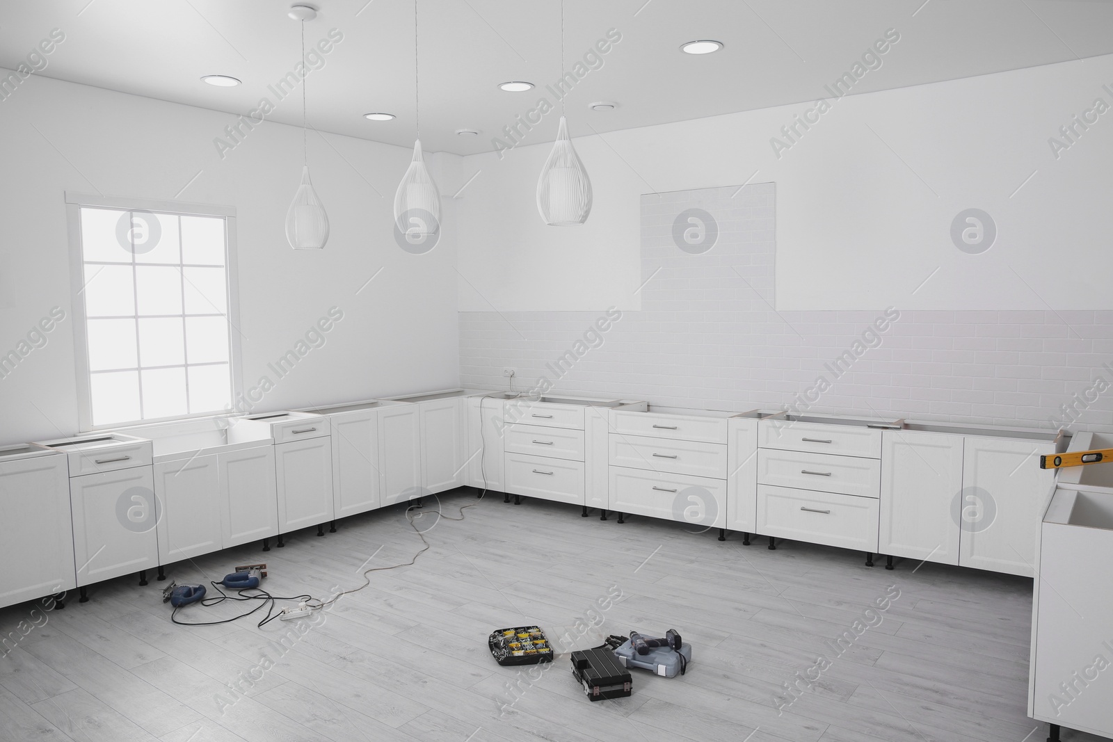 Photo of Stylish kitchen interior with newly installed furniture